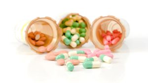Three prescription pill bottles tipped over with various medications spilling out, representing challenges when anxiety medications don’t work as expected.