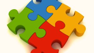 A four-piece colorful puzzle symbolizing autism awareness, a widely debated symbol in the autistic community.