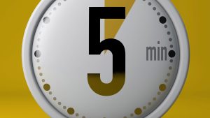 Close-up of a timer set to five minutes on a yellow background, symbolizing the 5 Minute Rule for ADHD and motivation to start tasks.