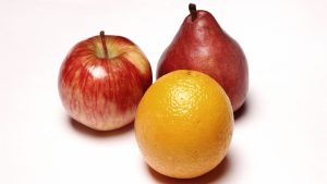 Apple, pear, and orange side by side representing differences between AuDHD, ADHD, and Autism.