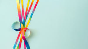 How the Autism Test Can Illuminate Personal Experiences Colorful ribbon loop symbolizing neurodiversity on a light blue background