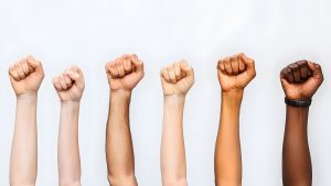 Women With AuDHD vs ADHD: Strategies For Success Raised hands symbolizing unity and empowerment—representing women with AuDHD and ADHD embracing neurodiversity and strength.